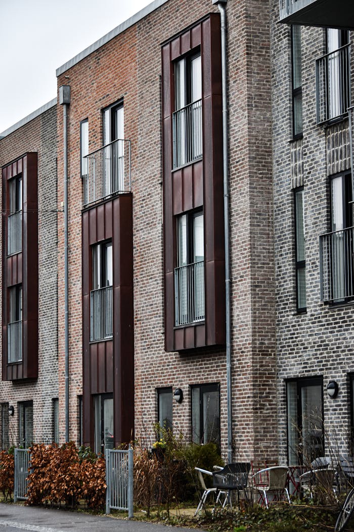 Contemporary brick apartment building facade with metal accents, showcasing urban residential architecture.