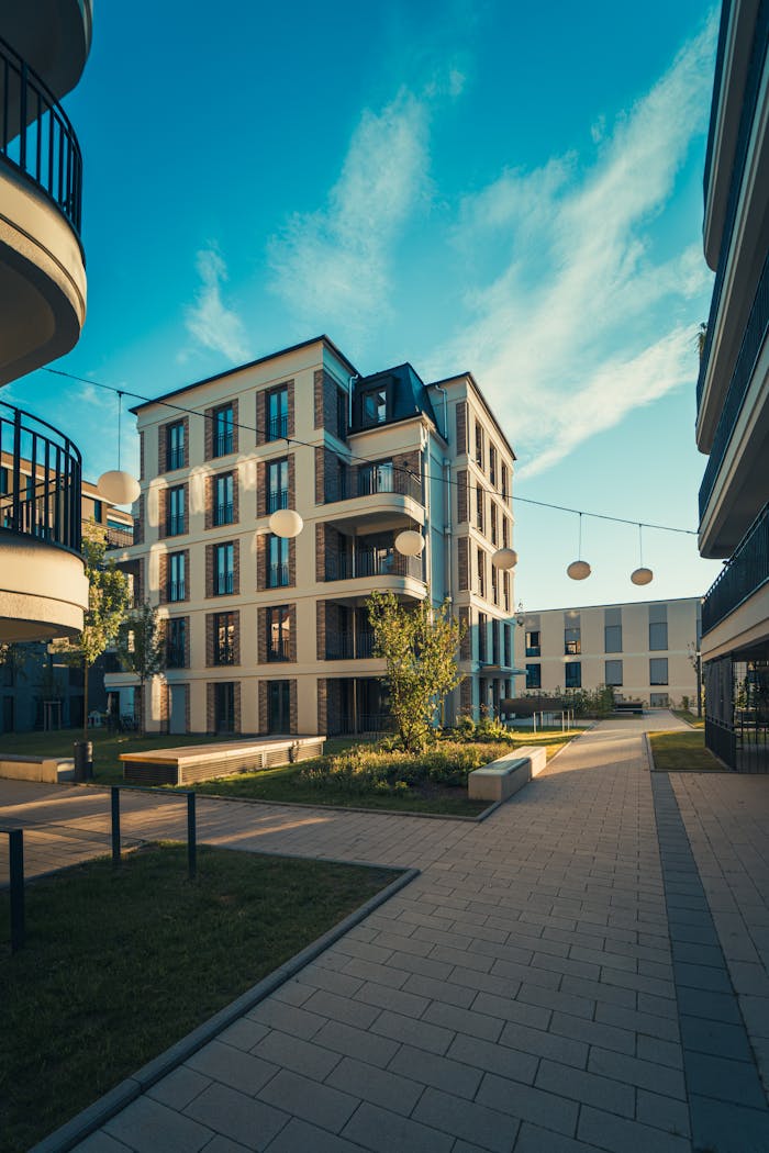 Modern apartment complex under clear blue skies, showcasing contemporary architecture and urban living.