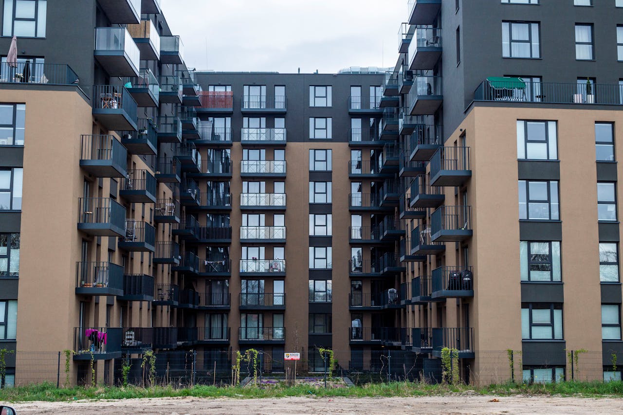 Contemporary apartment building facade with balconies in an urban setting.